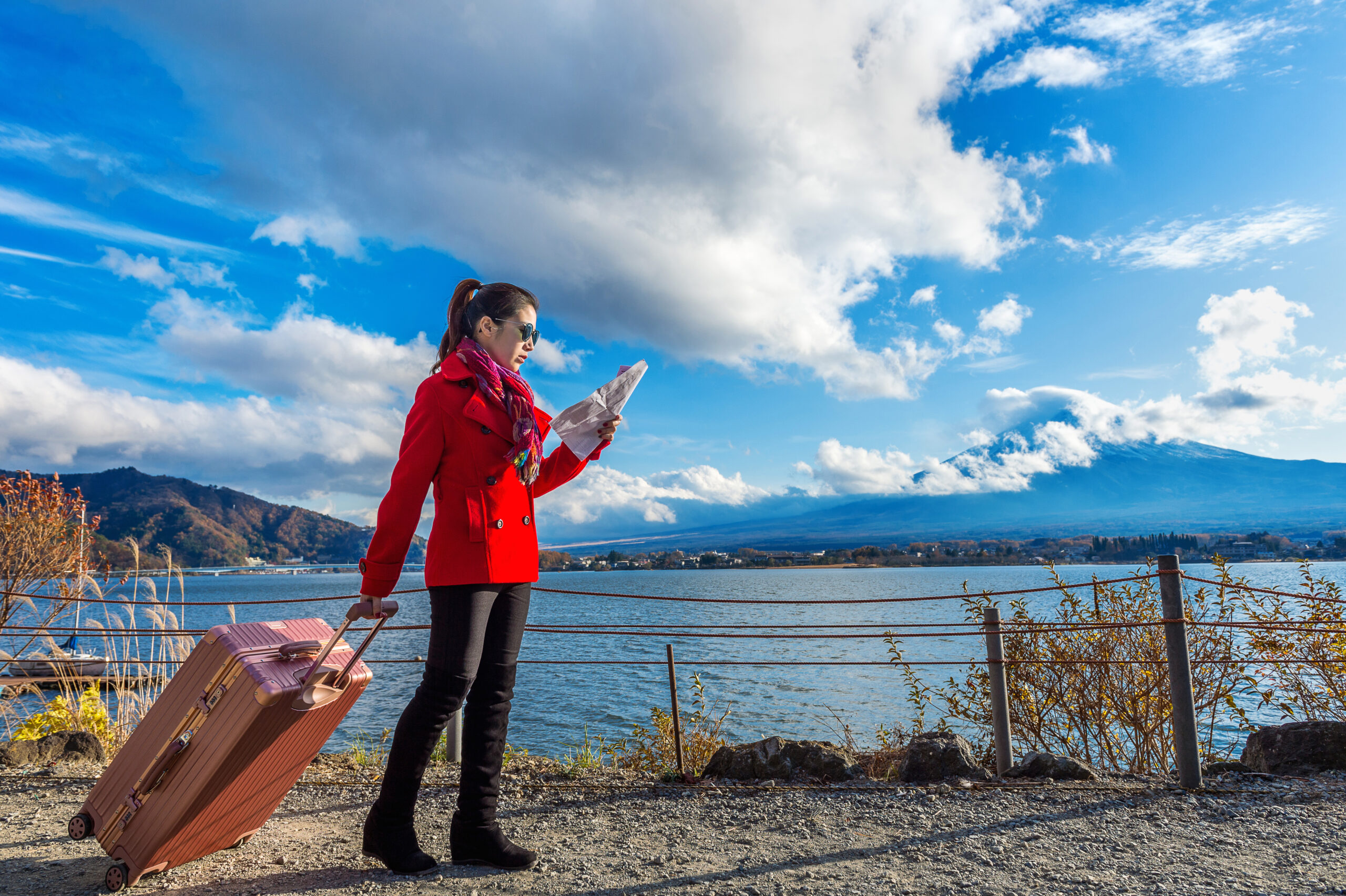 Tourist with baggage and map at Fuji mountain, Kawaguchiko in Japan.
